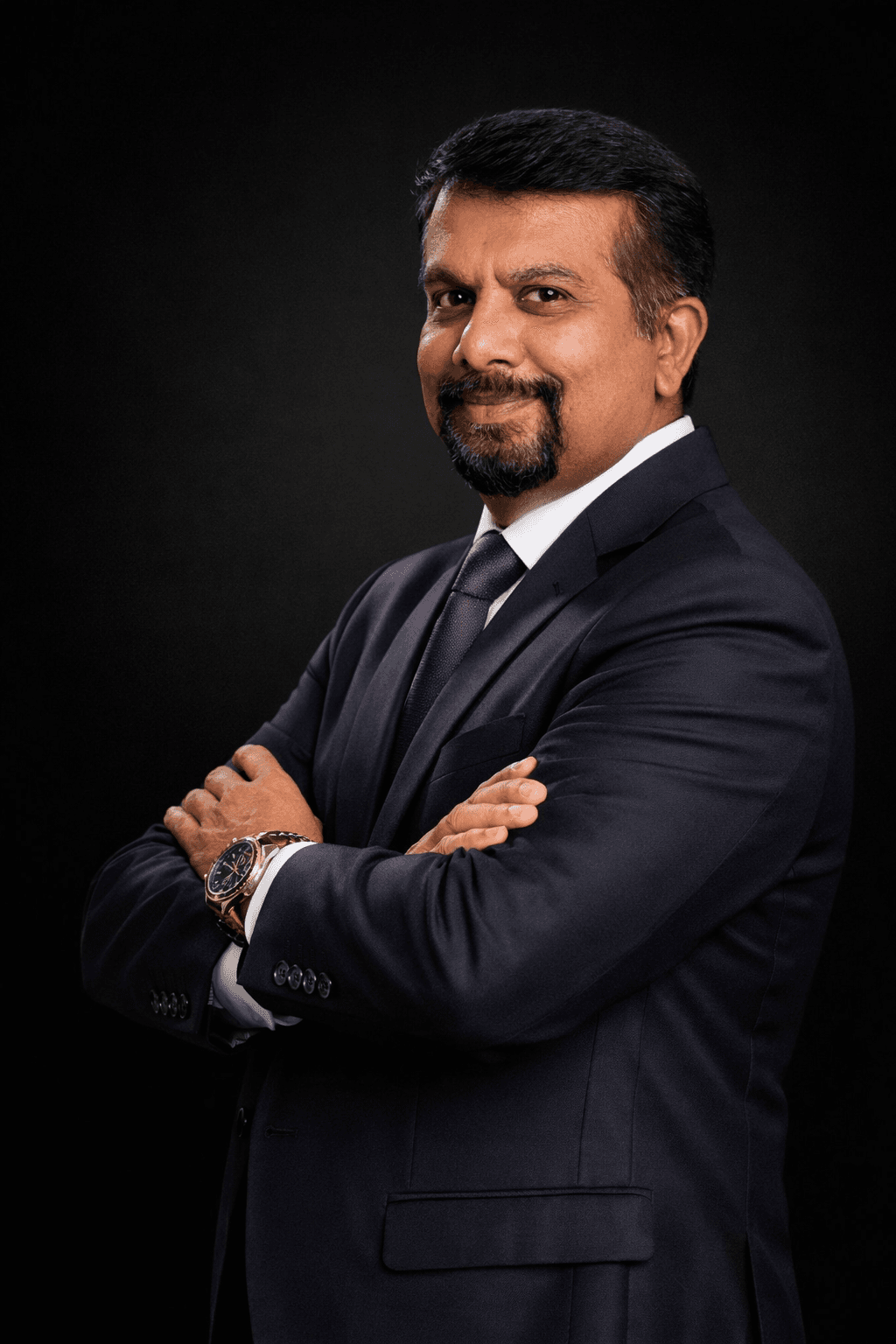 A team of professional electricians in uniform discussing blueprints inside a building under construction.